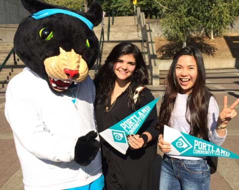 two female students with PCC Mascot